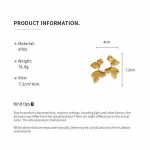 Detailed view of gold leaf drop earrings showing material, weight and size info.