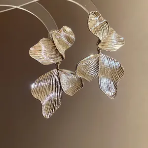 Exquisite macro view of elegant gold leaf texture drop earrings in retro style