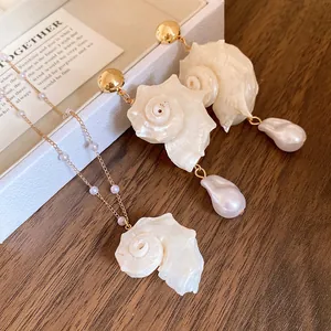 Detailed view of vacation style seashell and conch jewelry set with baroque pearl drops