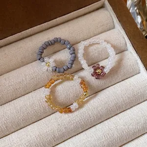 Three pieces set of handmade vintage glass seed bead flower stretch rings in a velvet box