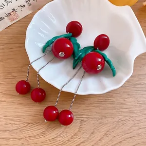 Sweet red cherry earrings with green leaves and long silver tassel in a white shell bowl