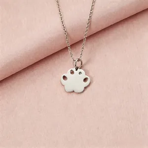 Detail view of a silver stainless steel paw pendant necklace with a sparkling rhinestone.