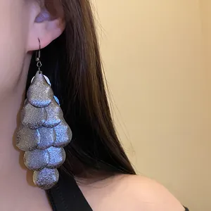 Detailed close-up of silver matte drop tassel earrings with a vintage multi-layer design.