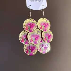 Detailed macro view showing the floral print on bohemian multi-disc gold drop earrings
