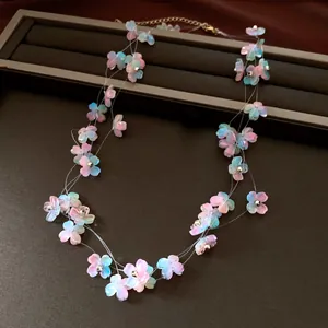 Detailed macro view of a pastel acrylic flower necklace with multi-layer transparent threads