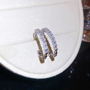 Elegant C-shaped hoop earrings with sparkling cubic zirconia in silver-toned finish