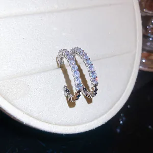 Close-up detail of silver-tone C-shaped hoop earrings featuring brilliant clear zirconia stones