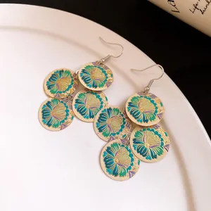 Detailed view of bohemian enamel floral earrings with tiered geometric tassel design