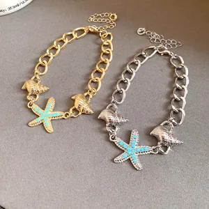 Detailed view of starfish and seashell charms on gold and silver chain bracelets