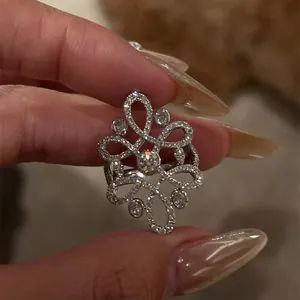 Close-up detail of vintage silver hollow flower ring with sparkling zircon stones