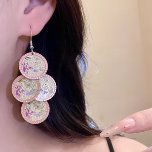 Detailed view of floral enamel dangle earrings featuring four layered circular discs.