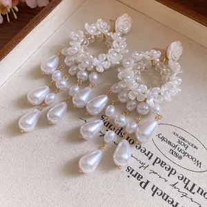 Macro detail shot showing French vintage resin flowers and water drop pearls of earrings