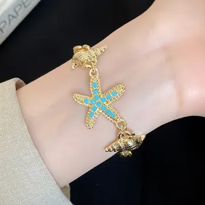 Exquisite fashion gold starfish and conch shell charm bracelet with blue beads detail