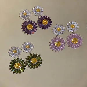 Elegant daisy flower drop earrings with sparkling colorful zircon stones on gold mirror surface