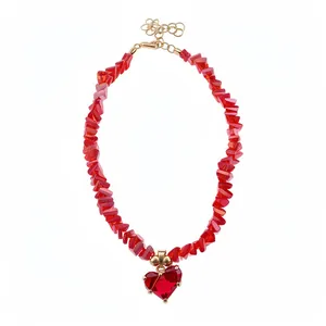 Elegant red crystal beaded necklace with heart-shaped pendant on plain white background