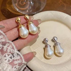 Elegant teardrop pearl earrings with wrinkled gold and silver metal studs for women