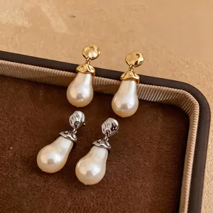 Elegant teardrop pearl drop earrings with irregular hammered gold and silver caps