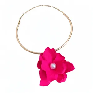 Elegant gold-tone choker necklace featuring a large fuchsia flower with a central pearl.