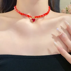 Close-up of a red crystal beaded choker necklace featuring a heart-shaped pendant.