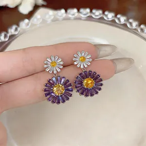 Detailed view of elegant zircon flower drop earrings featuring purple and white daisy petals
