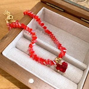Detailed view of elegant red crystal beaded necklace featuring a heart-shaped pendant