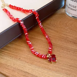 Detailed view of an elegant red crystal beaded necklace featuring a faceted heart pendant.