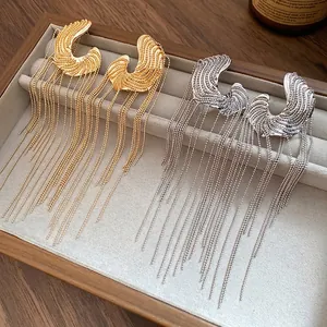 Luxurious C-shaped long tassel drop earrings set in gold and silver metallic finishes