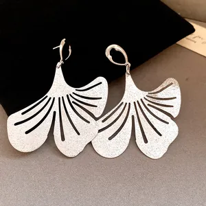 Detailed view of silver ginkgo leaf earrings with vintage wrinkled metal finish.