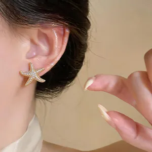 Exquisite starfish stud earrings with pavé zircon stones in 18K gold plated finish