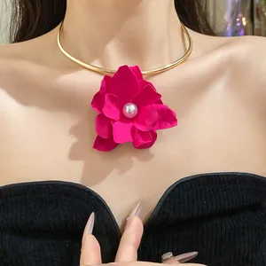 Detail view of an elegant gold choker with a large magenta pearl flower pendant.