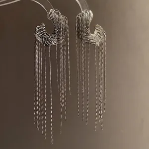 Elegant silver C-shaped hoop earrings with long flowing delicate metallic tassels
