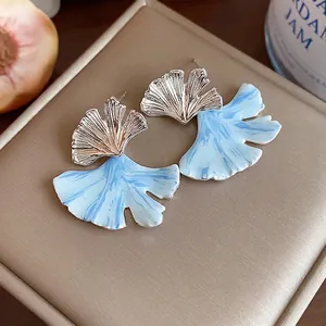 Elegant ginkgo leaf enamel stud earrings with light blue marbling and silver finish