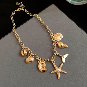 Detailed view of a gold ocean-themed necklace featuring starfish and seashell charms.