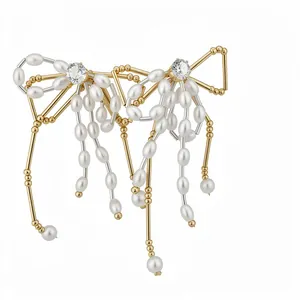 Elegant gold-tone bow stud earrings featuring white oval pearls and brilliant clear zircons
