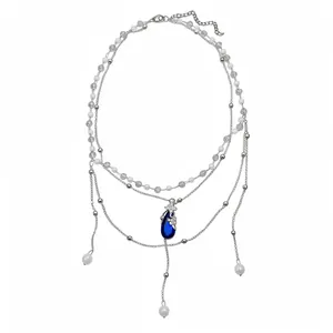 Elegant double-layer necklace featuring pearls and a vivid blue teardrop butterfly pendant