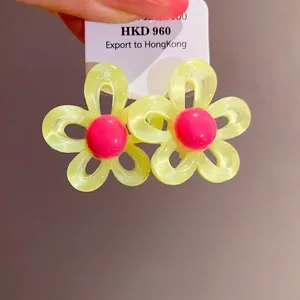 Elegant floral resin stud earrings with pink center and translucent yellow petals