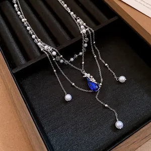 Double layer silver necklace with pearls, butterfly charm and blue water drop pendant