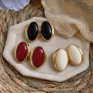Vintage oval resin stud earrings in black, red, and white with elegant gold frames