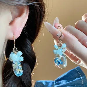 Handmade ethnic style resin drop earrings with natural stones and blue dried flowers