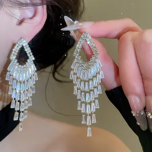 Exquisite detailed macro shot of sparkling zircon geometric tassel drop earrings for women