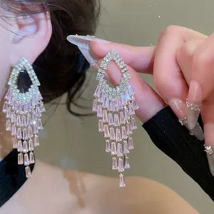 Elegant pink crystal chandelier earrings with geometric tassel design and silver needles.