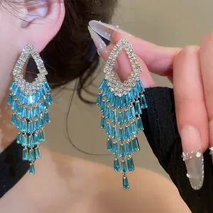Detail shot of silver-tone tassel earrings with blue zircons and sparkling rhinestones