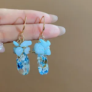Handmade ethnic style drop earrings with blue natural stones and dried flower resin