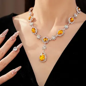 Elegant luxury necklace set with yellow oval and teardrop crystals on a diamond-studded chain