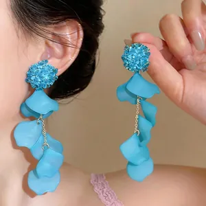 Stylish blue acrylic petal tassel earrings with glass flower beads for vacation wear.