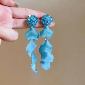 Blue glass flower earrings with acrylic petal tassels for a resort style look.
