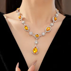 Detailed view of luxury yellow pear-shaped crystal necklace with silver pavé stones