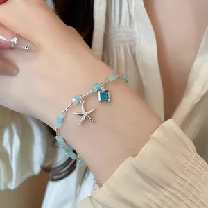 Detailed view of elegant summer starfish bracelet featuring blue square charm and frosted beads