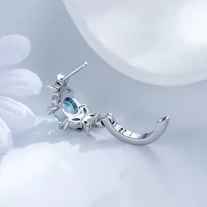 Exquisite flower-shaped ear buckle with sky blue zircon in a silver finish design