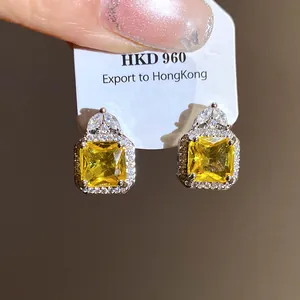 Detailed view of elegant square yellow zircon stud earrings with silver setting